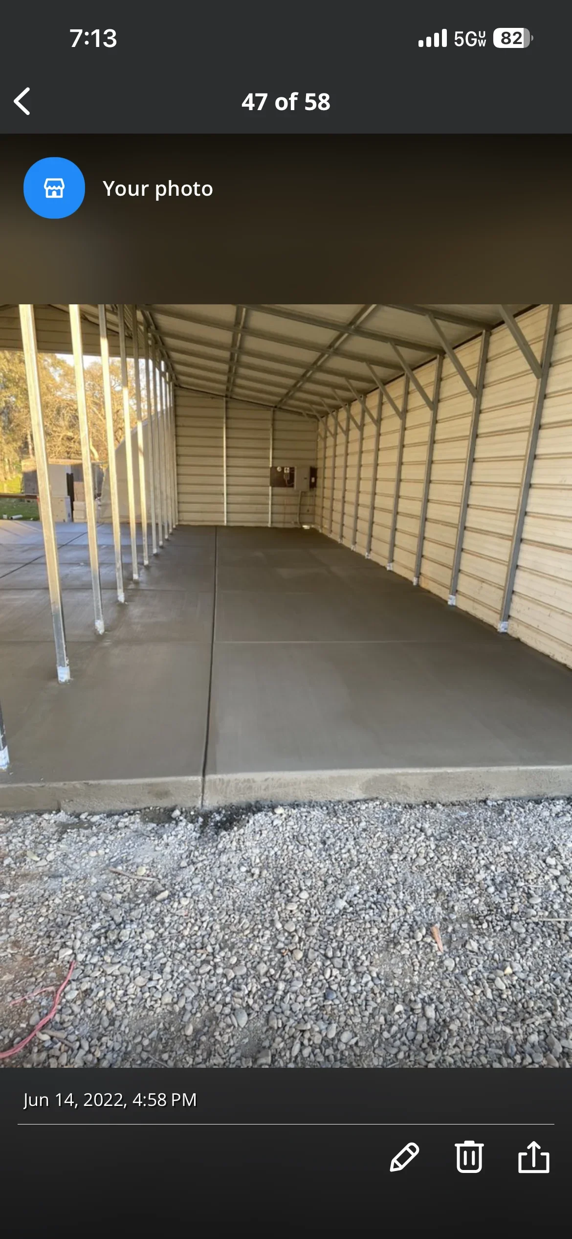 Finished concrete pad with metal carport frame and gravel base