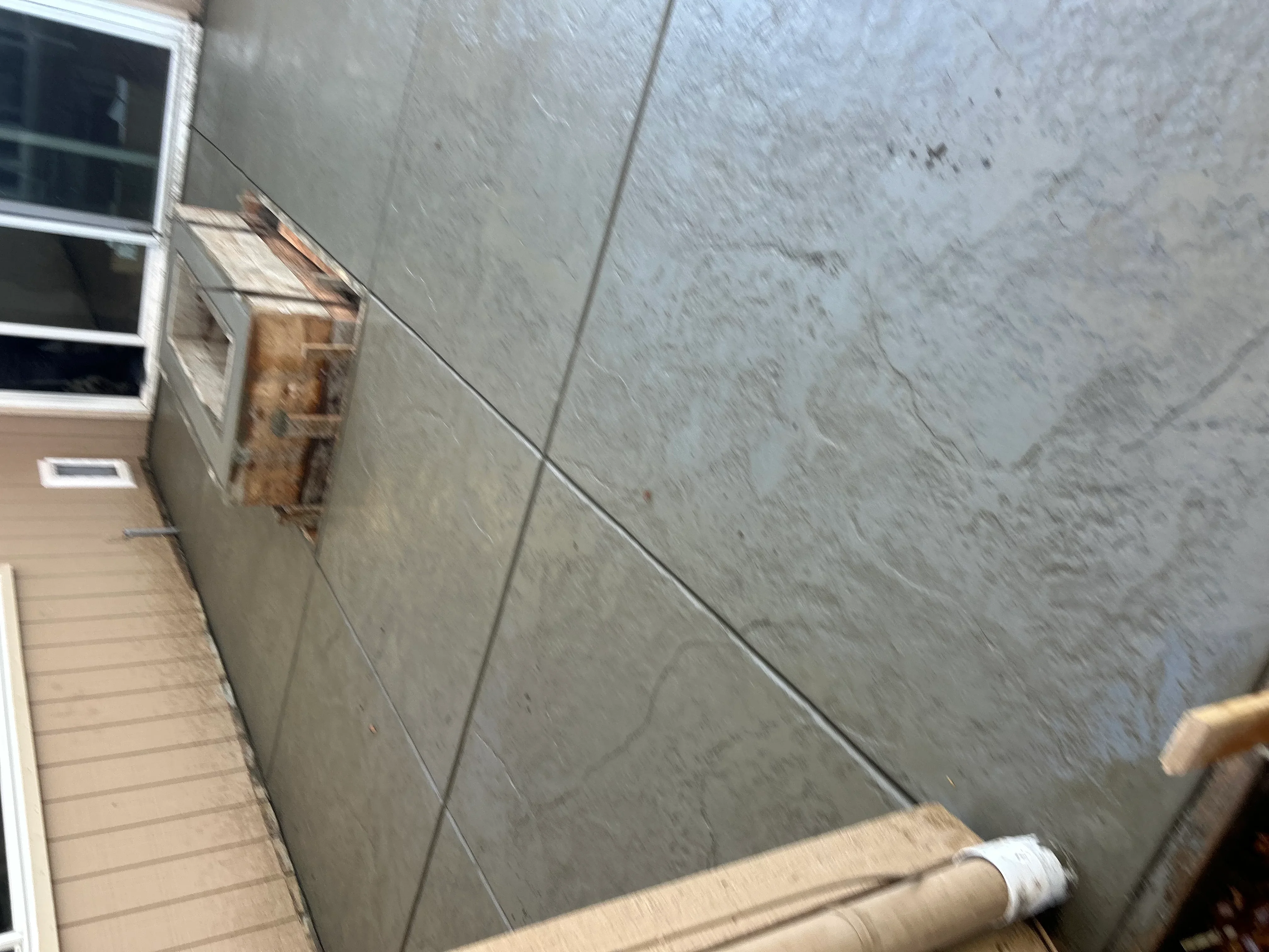 Finished concrete wall with control joints and window opening in Sacramento