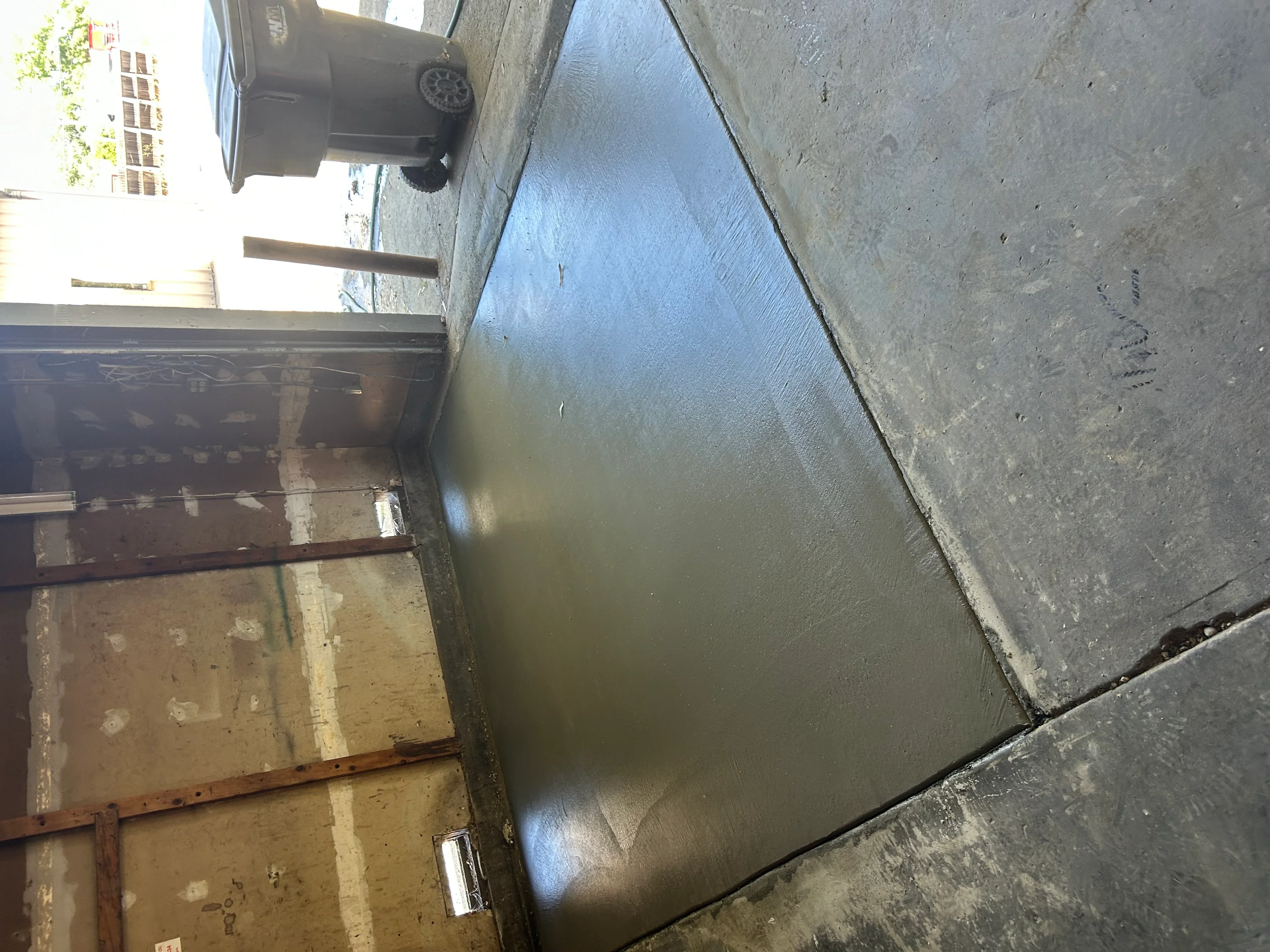 Newly installed concrete driveway with smooth finish and clean edges