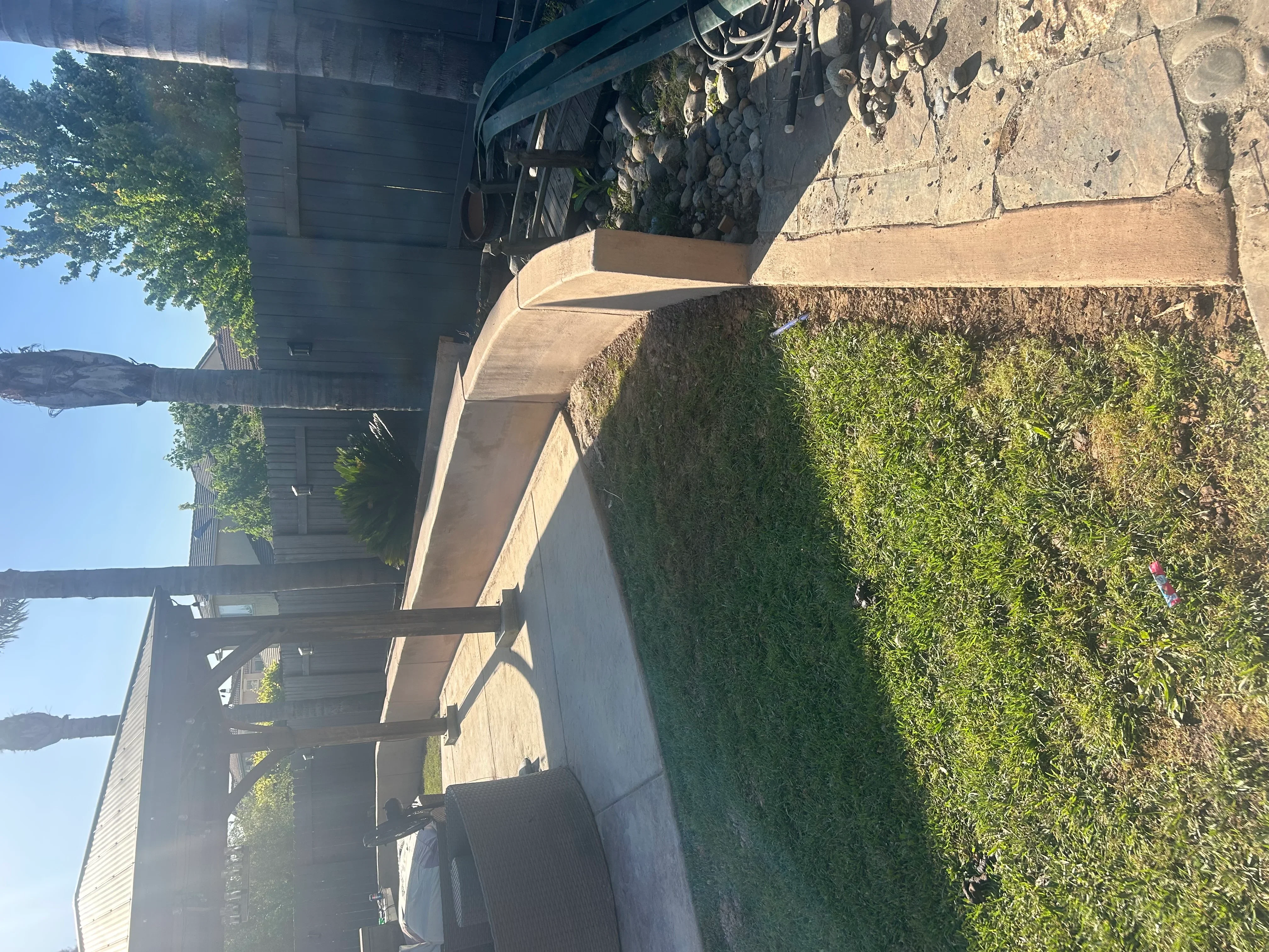 Curved concrete driveway with smooth finish and professional edging