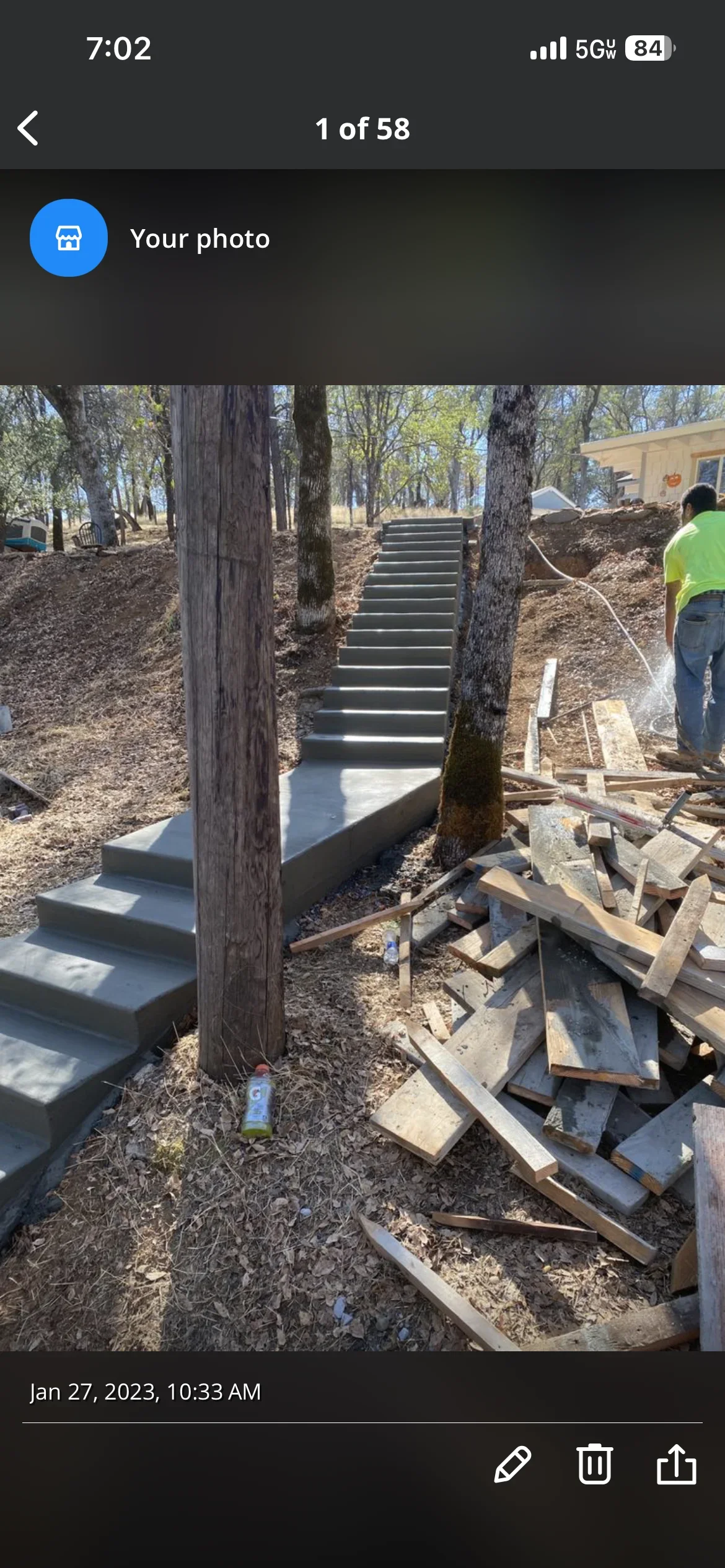 Newly poured concrete stairway with multiple steps descending through wooded residential lot